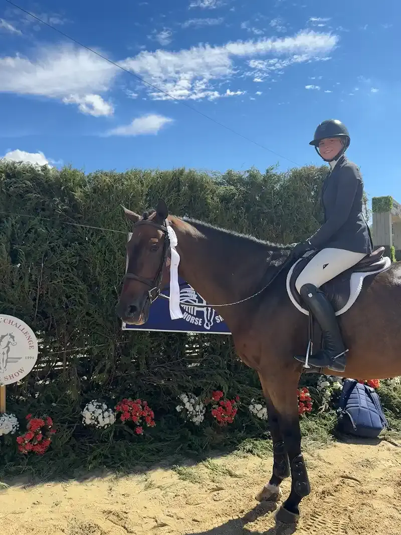 Rider on horseback with a ribbon at a Cedar Brook Farm show